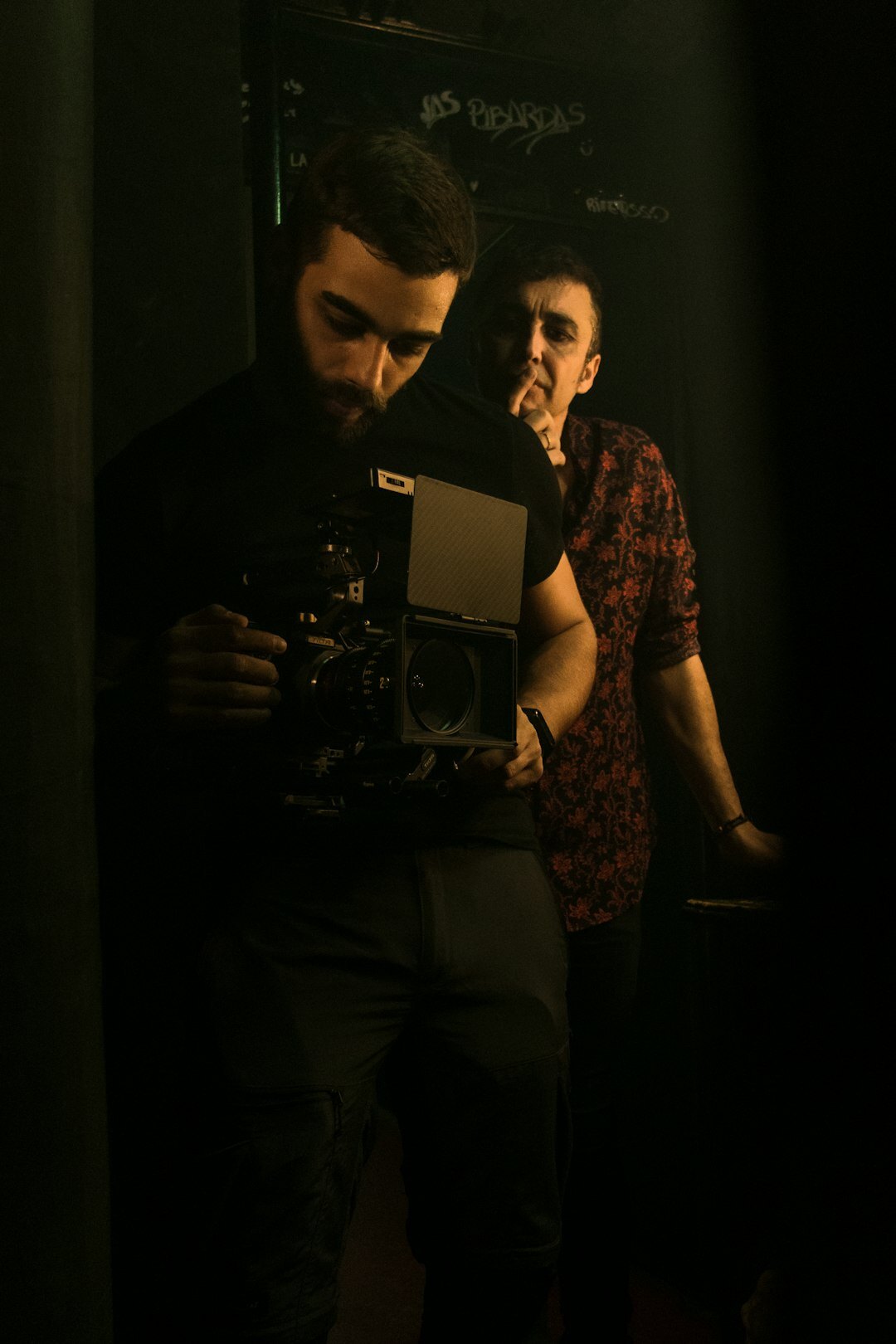 Turkish broadcast director speaking firmly to a camera operator backstage